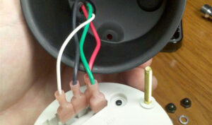 Four wires plugged into the back of a tachometer